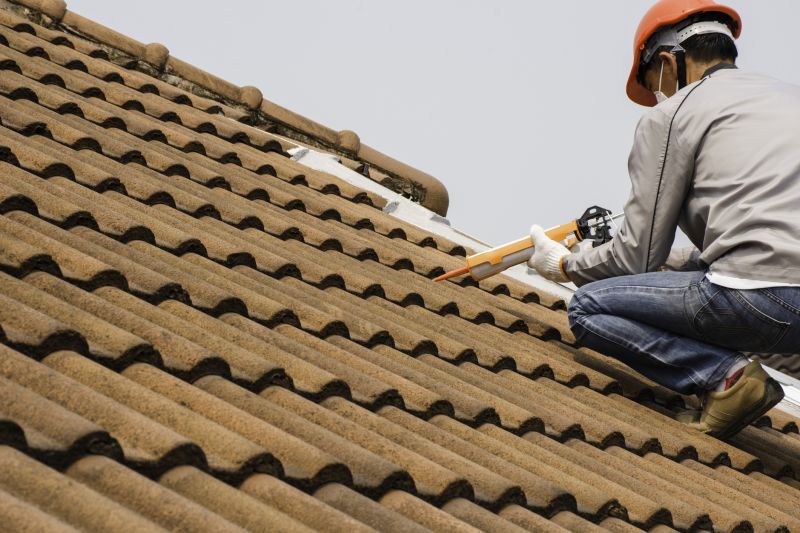 Professional roofers working on a home